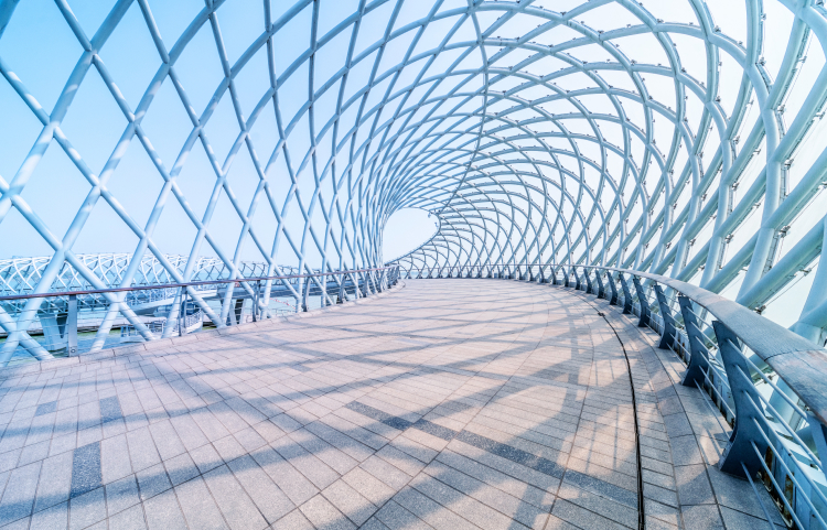 Curved steel lattice beams over a long bridge path